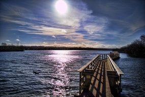 narrow wooden bridge over the lake