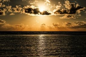 bright sun in the clouds over the ocean