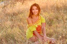 girl in a yellow dress in the sunset rays