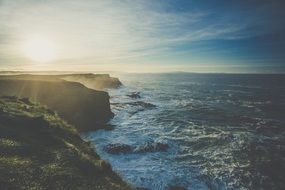 the waves beat on the rocky shore