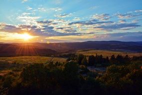 colorful scenic Sunset above distant mountains at summer
