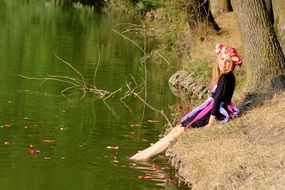 blonde in a wreath near the water