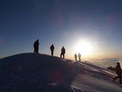 silhouettes of people in the mountains