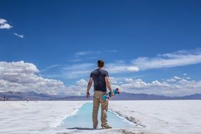 man with a skateboard on salt marshes in argentina