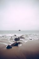 stones on a sandy ocean beach