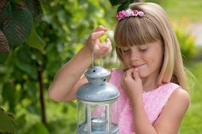 young girl in oink dress with lantern