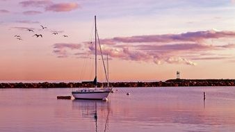 oceanfront sailboat at dusk