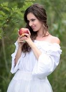 young woman with apple in hands