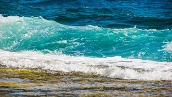 white foam on blue ocean wave