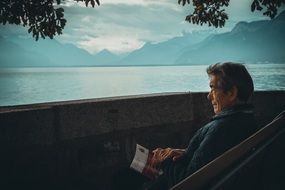 man reading on the city coast