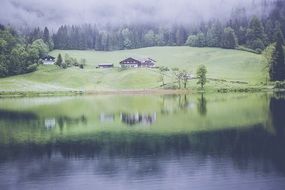 panorama of alpine lake in the fog