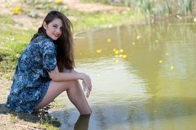woman with long hair by the lake