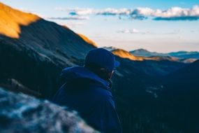 tourist on a mountainside at sunset