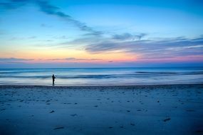 man catching fish in the evening