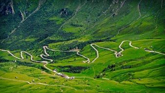 bird's-eye view of a mountain road and green valley in Veneto