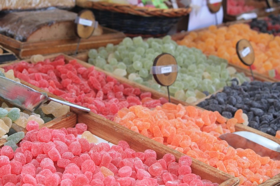 colorful sweet fruits in sugar on the market