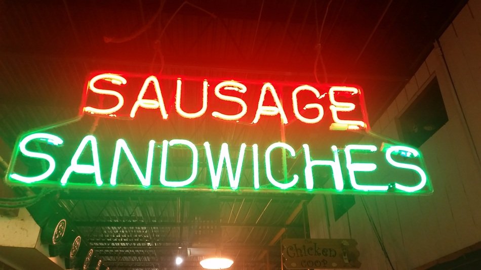 luminous sign of sausages and sandwiches