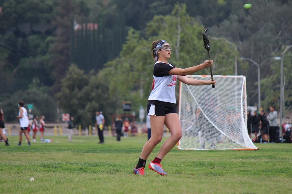 girl in lacrosse on the field