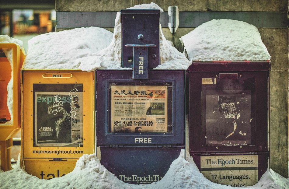 multi-colored newsstands under the snow