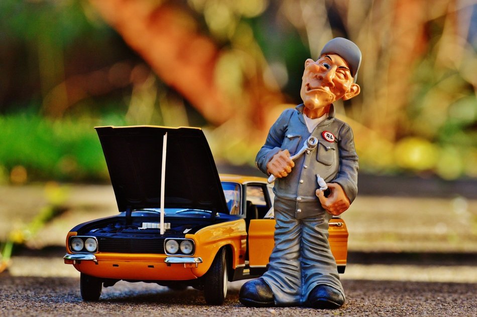 figure of the master near the model of a classic car