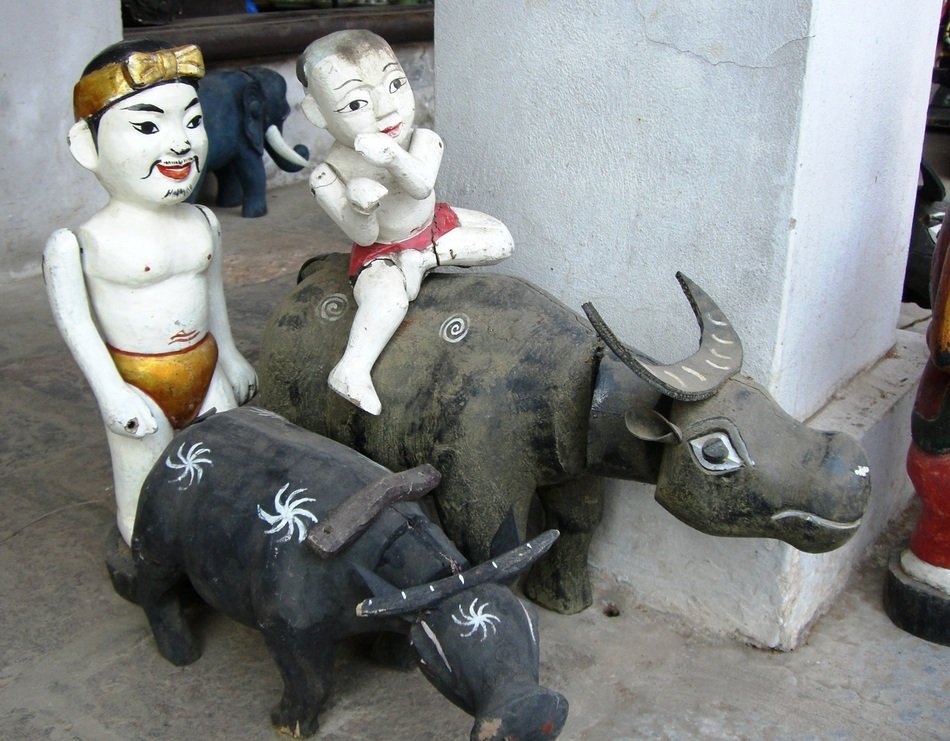 figures of people sitting on bulls