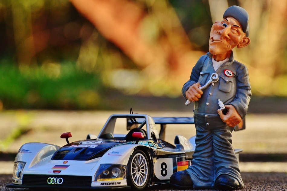 figure of the master near the racing car
