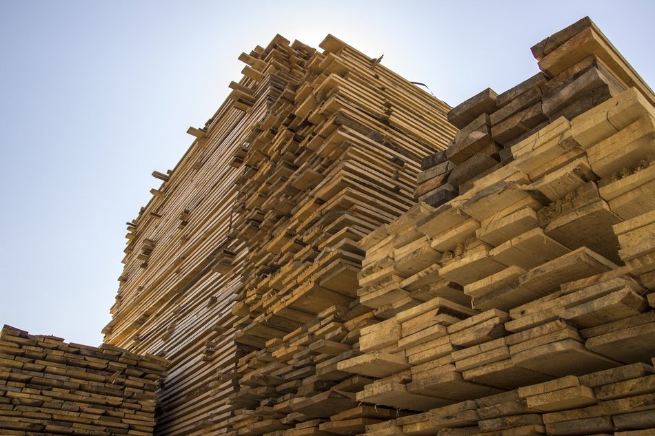 high Stacks of Wooden Planks at sky