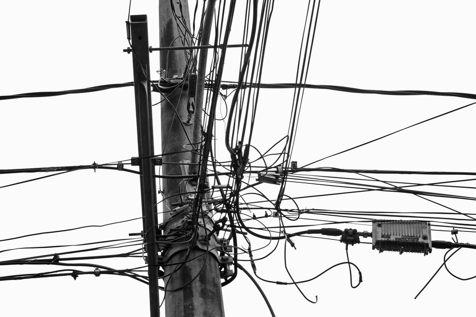 black and white image of power lines at sky background