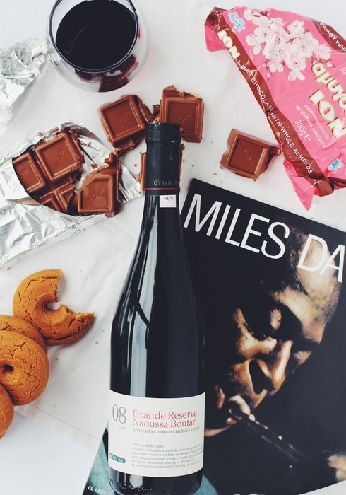 bottle of red wine, cookies and chocolate
