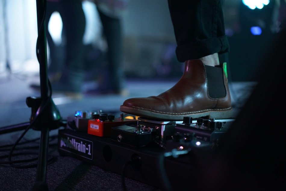 musician's foot on the piano pedal