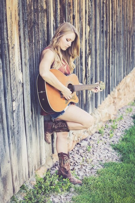 girl with a guitar near the fence