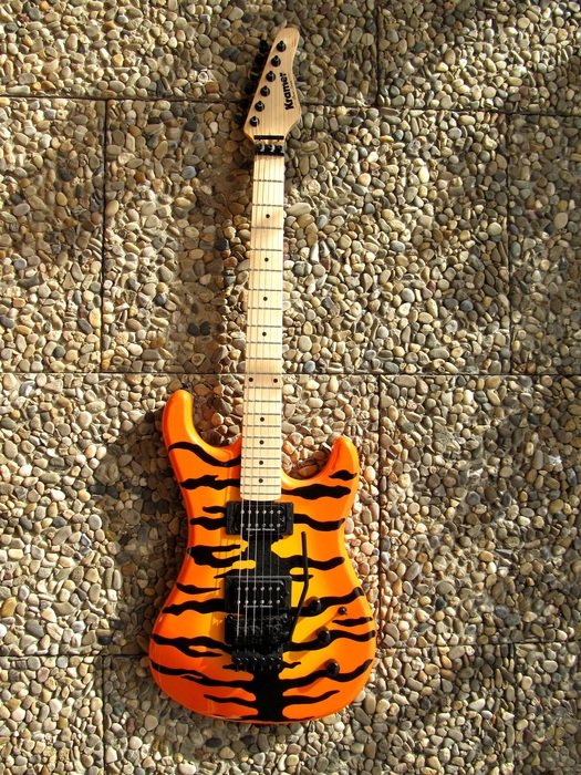 painted electric guitar on a wall