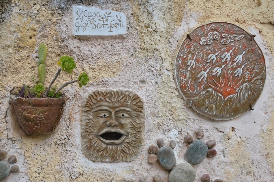 Colorful ornamental drawings and plants on the wall of the building