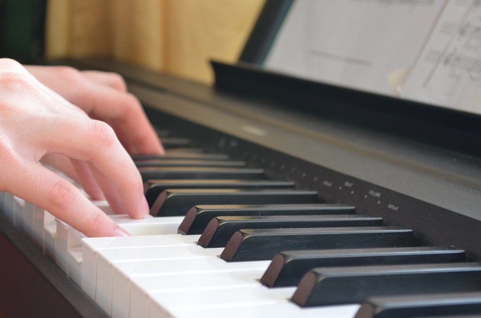 hands on piano keys close up