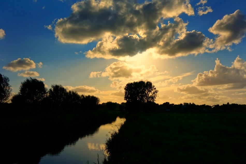 sunset behind the clouds in holland
