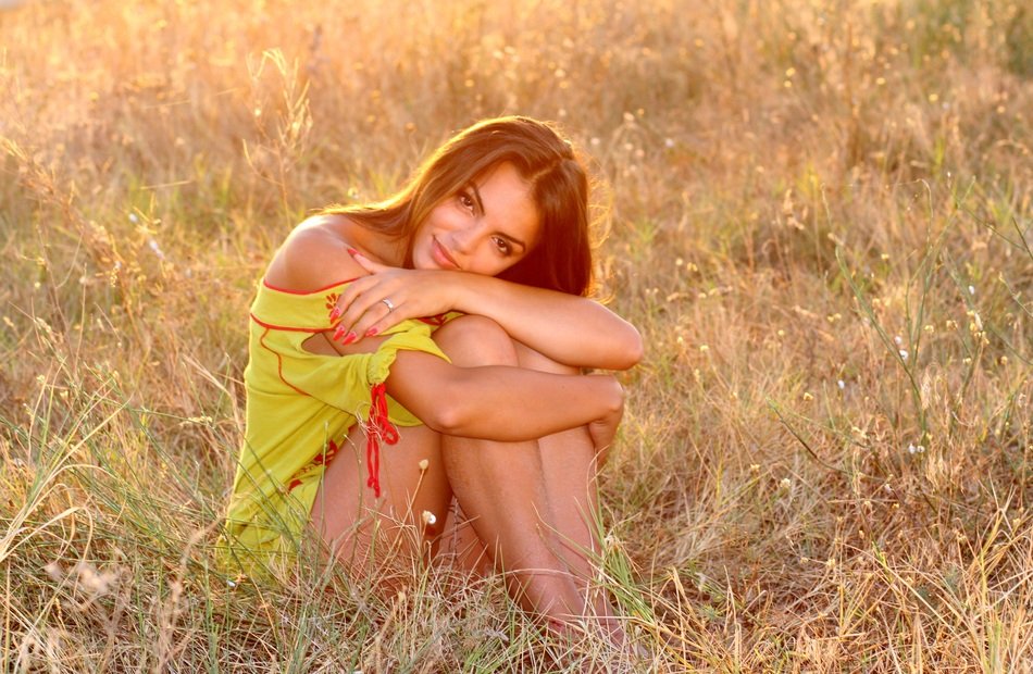beautiful woman posing on the wild meadow