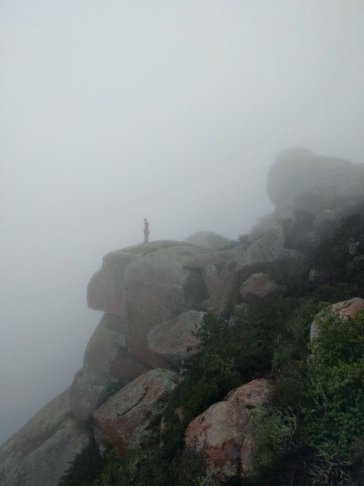 silhouette of a Man on the misty rocks