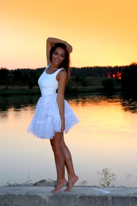 girl in white near the lake