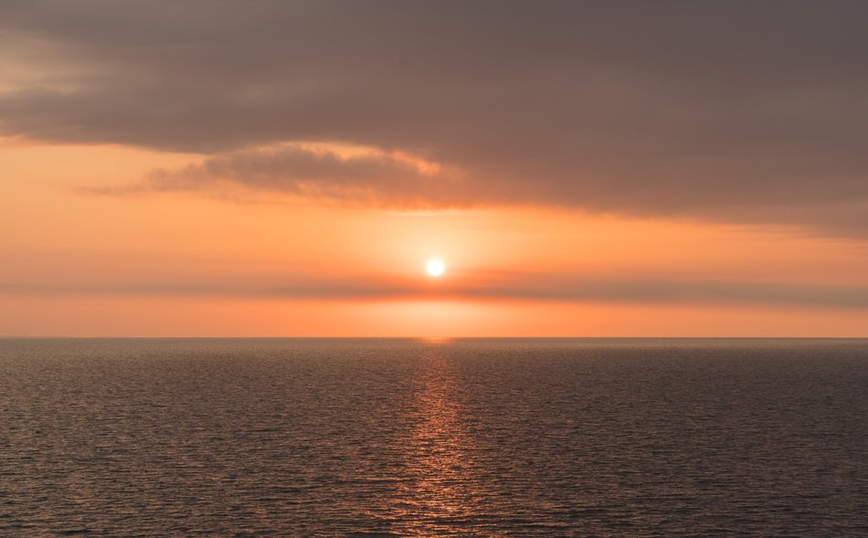 orange morning sun above the water
