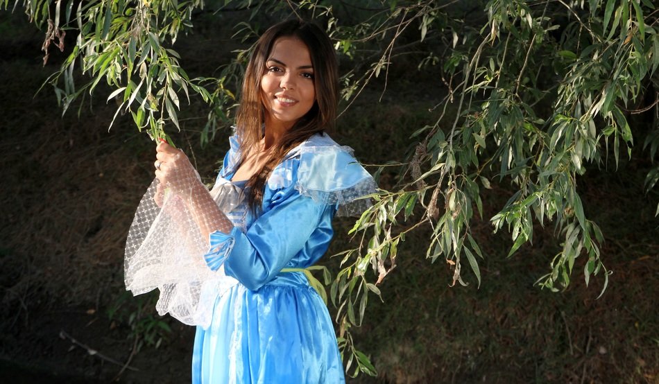 woman in princess dress by willow tree
