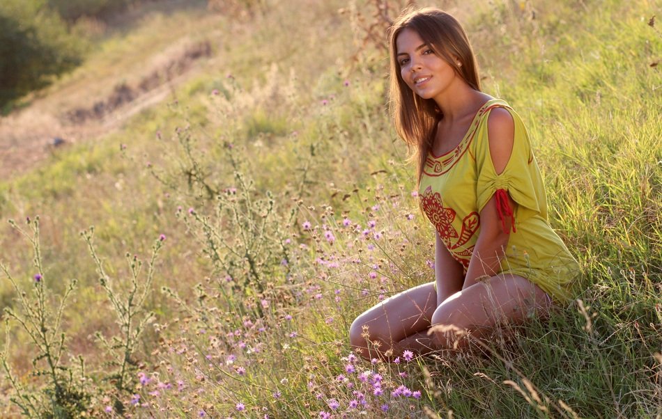 beautiful woman on the meadow in evening