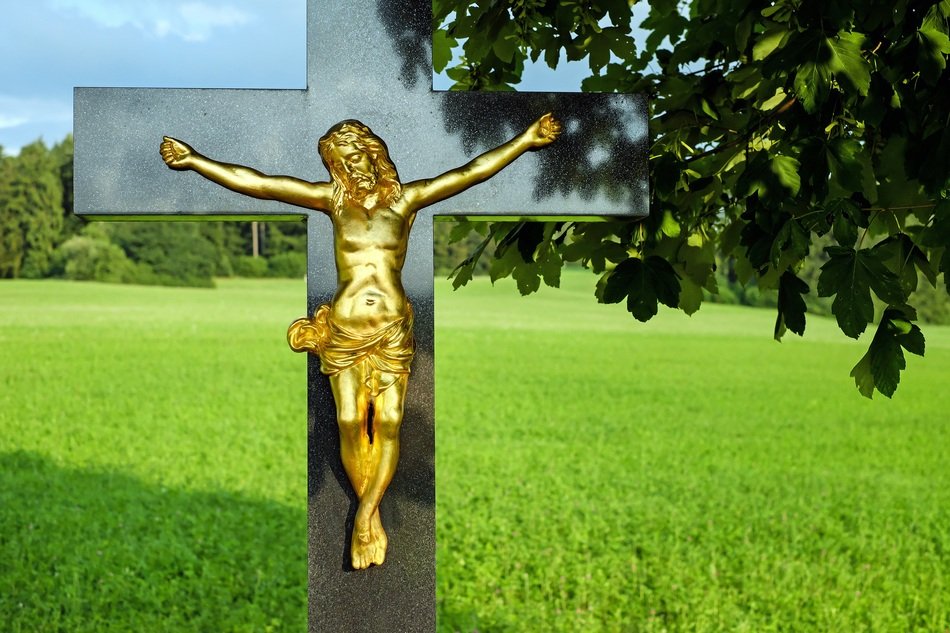 golden jesus on black cross