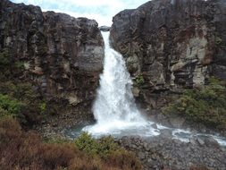 waterfall in the mountains of new zealand