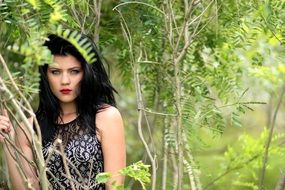 photo of brunette in a green forest