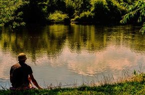 Picture of Man is fishing on a lake beach