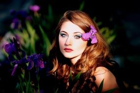 photo portrait of a red-haired girl with iris in her hair