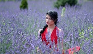 brunette woman in red dress in the lavender field