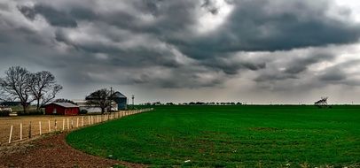 green farm field on a cloudy day