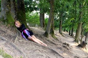 girl sleeping in a forest under a tree