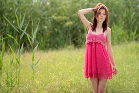 young woman in short pink dress